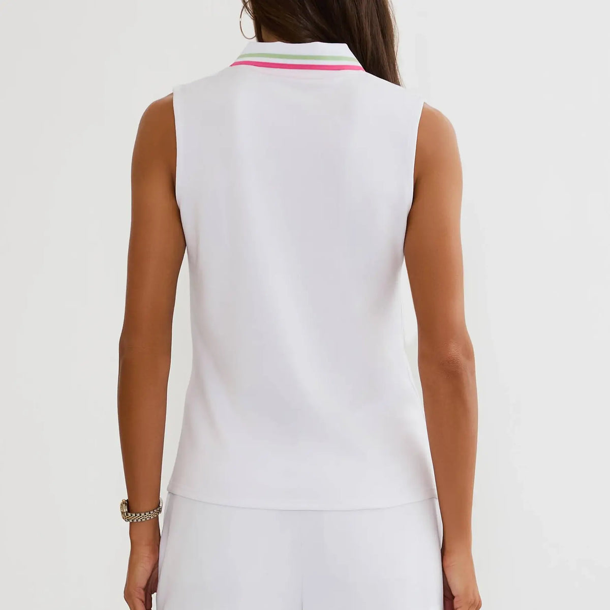 A woman shown from the back wearing a sleeveless white polo shirt with a striped collar in pink, green, and white, paired with matching white bottoms against a plain white background.